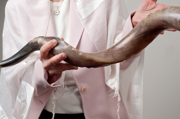 close-up shot of Suri holding a shofar